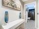 Stylish hallway with decorative floor tiles, a console table, and views into a laundry room at 6659 Times Square Ave 38-103 # Orlando, Orlando, FL 32835