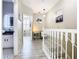 Bright hallway with art, light wood floors, and views into a bathroom and room with plantation shutters at 6659 Times Square Ave 38-103 # Orlando, Orlando, FL 32835