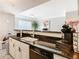 A kitchen area is equipped with white cabinets, dark countertops, and stainless steel appliances at 6659 Times Square Ave 38-103 # Orlando, Orlando, FL 32835