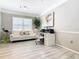 Bright living room features a stylish white sofa, desk area, and light gray wood floors at 6659 Times Square Ave 38-103 # Orlando, Orlando, FL 32835