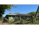 Side angle view of home featuring a satellite dish on the roof and lots of exterior foliage at 722 Belair Ave, Lakeland, FL 33801