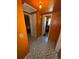 Hallway area featuring patterned tile flooring, leading to multiple rooms and doors at 722 Belair Ave, Lakeland, FL 33801