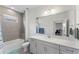 Updated bathroom features a shower/tub combo, sleek vanity with ample storage, and neutral design elements at 7465 Wing Span Way, Harmony, FL 34773