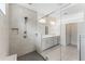 Modern bathroom showcasing sleek frameless glass shower, dual showerheads, and neutral tiling, designed for relaxation at 7465 Wing Span Way, Harmony, FL 34773