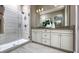 Elegant bathroom with double vanity, a glass-enclosed shower, and neutral color palette at 808 Blue Creek Dr, Haines City, FL 33844