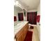 Bathroom featuring double sink vanity, neutral cabinets, and tile flooring with a shower and tub combo at 813 Marcel Loop, Davenport, FL 33837