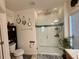 Well-lit bathroom showcasing a glass-enclosed shower with tiled walls and modern fixtures at 813 Marcel Loop, Davenport, FL 33837