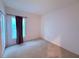 Empty bedroom with neutral walls, carpet, and a window with ample natural light at 813 Marcel Loop, Davenport, FL 33837