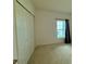 Neutral bedroom features a closet and a window at 813 Marcel Loop, Davenport, FL 33837