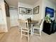 Cozy dining area with a round table, four chairs, and adjacent laundry room at 813 Marcel Loop, Davenport, FL 33837