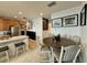 Kitchen area flows to the dining area, boasting stainless appliances and a breakfast bar at 813 Marcel Loop, Davenport, FL 33837