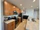 Well-lit kitchen featuring stainless steel appliances, plenty of counter space, and stylish cabinetry at 813 Marcel Loop, Davenport, FL 33837