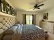 Bedroom with neutral tones, tufted headboard, and a large window offering natural light at 813 Marcel Loop, Davenport, FL 33837