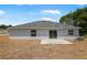 Exterior shot of backyard featuring a patio and gray facade at 101 Sail Way, Kissimmee, FL 34759