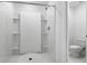 Bathroom featuring a walk-in shower with built-in shelving, and modern toilet at 101 Sail Way, Kissimmee, FL 34759