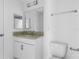Well-lit bathroom with a granite countertop, a white vanity, and a modern mirror at 101 Sail Way, Kissimmee, FL 34759