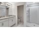Stylish bathroom featuring double vanity sinks, granite countertops, and a glass-enclosed shower at 101 Sail Way, Kissimmee, FL 34759