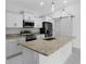Modern kitchen with stainless steel appliances, granite countertops, a barn door, and a stylish island at 101 Sail Way, Kissimmee, FL 34759