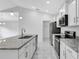 Well-equipped kitchen featuring white cabinets, stainless steel appliances, and a large island with a sink at 101 Sail Way, Kissimmee, FL 34759