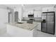 Modern kitchen with stainless steel appliances, granite countertops, and a stylish island at 101 Sail Way, Kissimmee, FL 34759