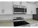 Close-up of modern stainless steel appliances and granite countertops in a well-designed kitchen at 101 Sail Way, Kissimmee, FL 34759