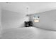 Bright living space featuring white tile flooring, a modern chandelier, and a dedicated desk area at 101 Sail Way, Kissimmee, FL 34759