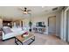 Spacious living room featuring a neutral color palette, modern furnishings, and seamless flow to other areas at 1019 Wisteria Way, Dundee, FL 33838