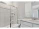 Bathroom featuring a toilet, shower with a glass door, and a modern vanity with a sink at 1027 Wisteria Way, Dundee, FL 33838