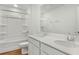 Bathroom featuring a bathtub and a double vanity with white cabinets and modern fixtures at 1027 Wisteria Way, Dundee, FL 33838