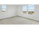 Bedroom with neutral walls, plush carpet, and a window that provides natural light at 1027 Wisteria Way, Dundee, FL 33838
