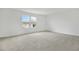 Bedroom with neutral walls, plush carpet, and a window that provides natural light at 1027 Wisteria Way, Dundee, FL 33838