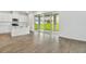 Bright living room featuring hardwood flooring, sliding glass doors, and an open layout at 1027 Wisteria Way, Dundee, FL 33838