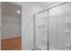 Bathroom featuring glass shower door and view into carpeted walk-in closet at 1031 Wisteria Way, Dundee, FL 33838
