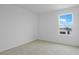 A bright bedroom featuring plush carpeting and a window overlooking neighborhood at 1031 Wisteria Way, Dundee, FL 33838