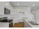 Bright kitchen featuring white cabinets, stainless steel appliances, and an island with white countertop at 1031 Wisteria Way, Dundee, FL 33838