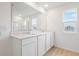 Modern bathroom with a double sink vanity, a large mirror, and a walk-in shower at 1035 Wisteria Way, Dundee, FL 33838