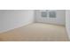 This is a cozy bedroom space with carpet flooring and a bright window at 1035 Wisteria Way, Dundee, FL 33838