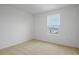 Bedroom space featuring carpet flooring and natural light from one window at 1035 Wisteria Way, Dundee, FL 33838
