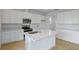 Bright kitchen featuring an island, white cabinetry, stainless steel appliances at 1035 Wisteria Way, Dundee, FL 33838