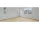A brightly lit living room showcases neutral wall paint and beautiful floors at 1035 Wisteria Way, Dundee, FL 33838