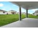 View from covered patio highlighting the spacious backyard with manicured lawn at 1035 Wisteria Way, Dundee, FL 33838