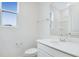 Clean bathroom featuring white cabinets, quartz countertops, and a shower at 1039 Wisteria Way, Dundee, FL 33838