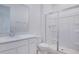 Bathroom featuring a white vanity with sink and a glass-enclosed shower at 1039 Wisteria Way, Dundee, FL 33838