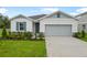 Charming single-Gathering home with a manicured lawn and a two-car garage at 1039 Wisteria Way, Dundee, FL 33838