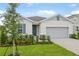 Inviting single-Gathering home featuring lush landscaping, a well-maintained lawn, and a two-car garage at 1039 Wisteria Way, Dundee, FL 33838