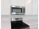 Close up of a well-equipped kitchen with stainless steel microwave and oven at 1039 Wisteria Way, Dundee, FL 33838