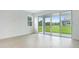 Open-concept living room featuring hardwood floors and sliding glass doors to the backyard at 1039 Wisteria Way, Dundee, FL 33838