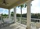 Expansive balcony featuring multiple seating areas and a peaceful view of the lush surroundings at 1057 Castle Pines Ct, Reunion, FL 34747