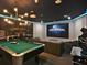 Entertainment basement with a home theater featuring Universal Studios and a pool table at 1057 Castle Pines Ct, Reunion, FL 34747