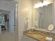 Well-lit bathroom featuring granite countertops, a large vanity mirror, and modern fixtures at 1057 Castle Pines Ct, Reunion, FL 34747